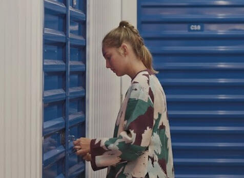 Young woman using digital access to open her internal storage unit at Locked Self Storage Alloa.